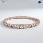 A rose gold tennis bracelet with a row of clear round-cut diamonds, displayed on a light gray background. The brand logos 'ARIA'S LAHA CUTTA' and 'Sparkle' are visible in the top corners.