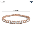 A rose gold tennis bracelet with a single row of round clear gemstones, shown on a white background with a measurement line indicating a 7-inch length. The ARIAS Lara Dutta brand logo is in the top left, and the Sparkle gemstone brand logo is in the top right.