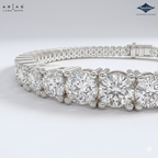 A close-up studio shot of a silver tennis bracelet with round clear gemstones, showing the detailed prong setting and clasp mechanism. The brand logos for 'Arias Lara Dutta' and 'Sparkles' are visible in the top corners.