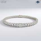 A silver tennis bracelet with a row of round-cut clear gemstones, displayed on a light gray gradient background. The ARIAS Lara Dutta brand logo is visible in the top left, and the Sparkles gem brand logo is in the top right.