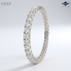 Silver bracelet with diamond accents on a light gray background