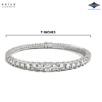 A silver tennis bracelet with round-cut clear stones, shown on a white background with a measurement line indicating a 7-inch width. The ARIAS LARA GUTTA logo is in the top left, and the Sparkle Diamonds logo is in the top right.