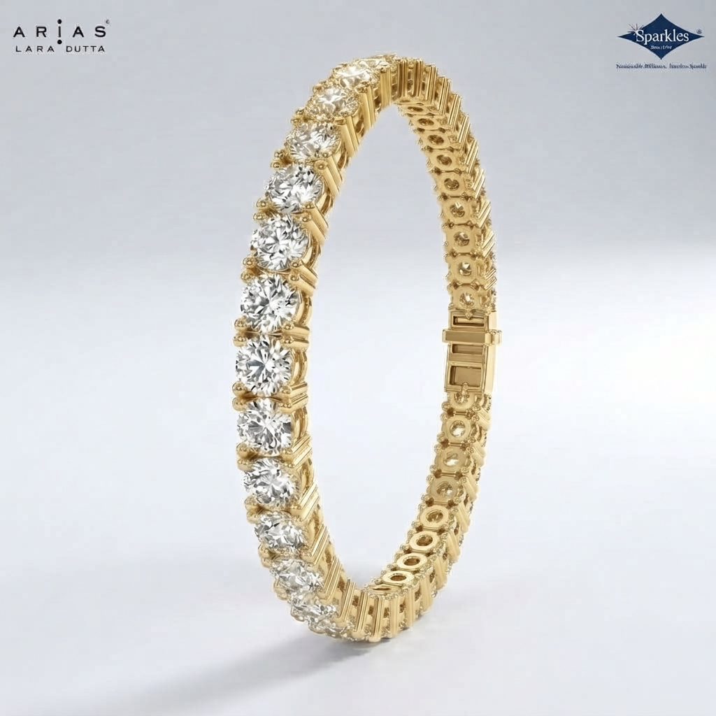 A yellow gold tennis bracelet featuring round brilliant-cut diamonds, shown on a light gray gradient background. The brand logos for 'Arias Lara Cutta' and 'Sparkle' are visible in the top corners.