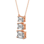 Rose gold necklace with three emerald-cut diamonds on a white background