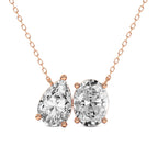 Rose gold necklace with two diamond pendants on a white background