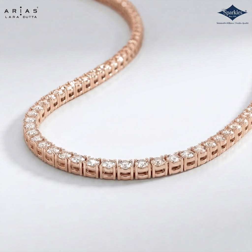 A close-up of a rose gold tennis necklace with clear gemstones, shown on a light gray background with ARIAS LARA GUTTA branding in the top left and a Sparkle certification badge in the top right.