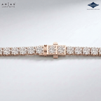 A close-up of a Lara Dutta Arias diamond tennis bracelet in rose gold, showing the clasp and several diamond-set links on a light gray background with brand logos in the corners.