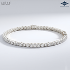 A silver tennis bracelet with round-cut clear stones, displayed in a circular shape on a light gray gradient background. The brand logos 'ARIA'S LAURA DUTTA' and 'Sparkles' are visible in the top corners.