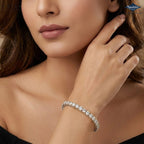 A close-up lifestyle shot of a woman wearing a sparkling silver tennis bracelet with clear stones. The brand logo 'Sparkle's' is visible in the top right corner.