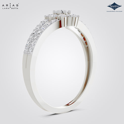 A white gold or platinum ring by Arias Lara Dutta, featuring a pavé-set row of clear stones on one half and a cluster of larger round stones on the other, shown on a light gray background.
