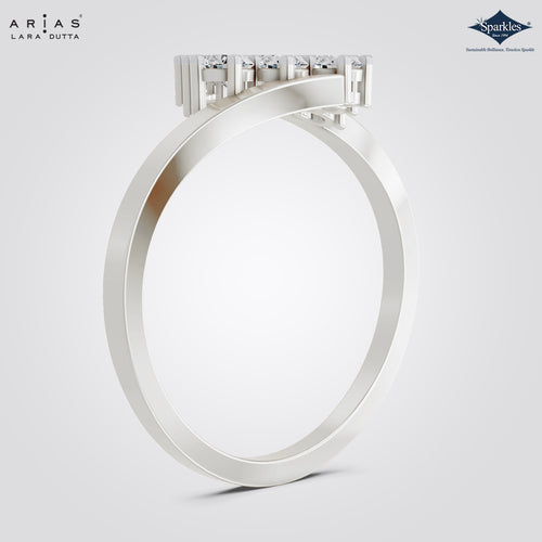 A silver-tone ring from ARIAS Lara Dutta, featuring a wide band and a rectangular cluster of clear gemstones on the top, shown against a light gray gradient background with brand logos in the corners.