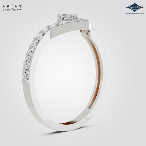 A close-up studio shot of a silver-tone ring band with a row of clear stones along the outer edge, shown on a light gray background. The brand names ARIAS LARA DUTTA and Sparkle are visible in the top corners.