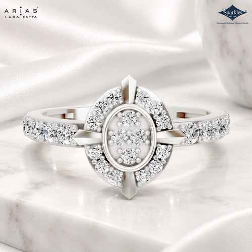 A silver-tone Lara Dutta Arias ring with clear pavé-set diamonds, featuring a central oval cluster and geometric side details, displayed on a white marble surface with draped white fabric.