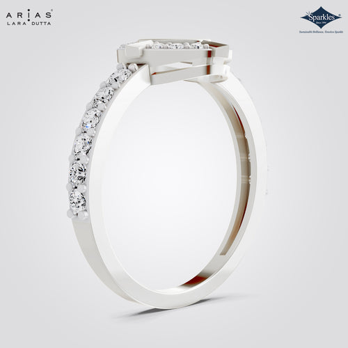 A white gold or platinum ring by Arias Lara Dutta, featuring a square bezel-set diamond crown and a pavé diamond band, shown on a light gray background with brand logos in the corners.