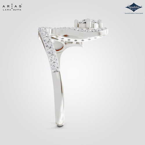 A silver-tone diamond ring shown from the side on a light gray gradient background, featuring a curved top with multiple round diamonds and a pavé-set diamond shank. The Arias Lara Dutta logo is in the top-left corner, and the Sparkle gemstone brand logo is in the top-right.
