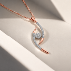 A rose gold necklace with a curved, openwork pendant set with small clear stones and a central round stone, displayed on a clean beige surface with soft shadows.