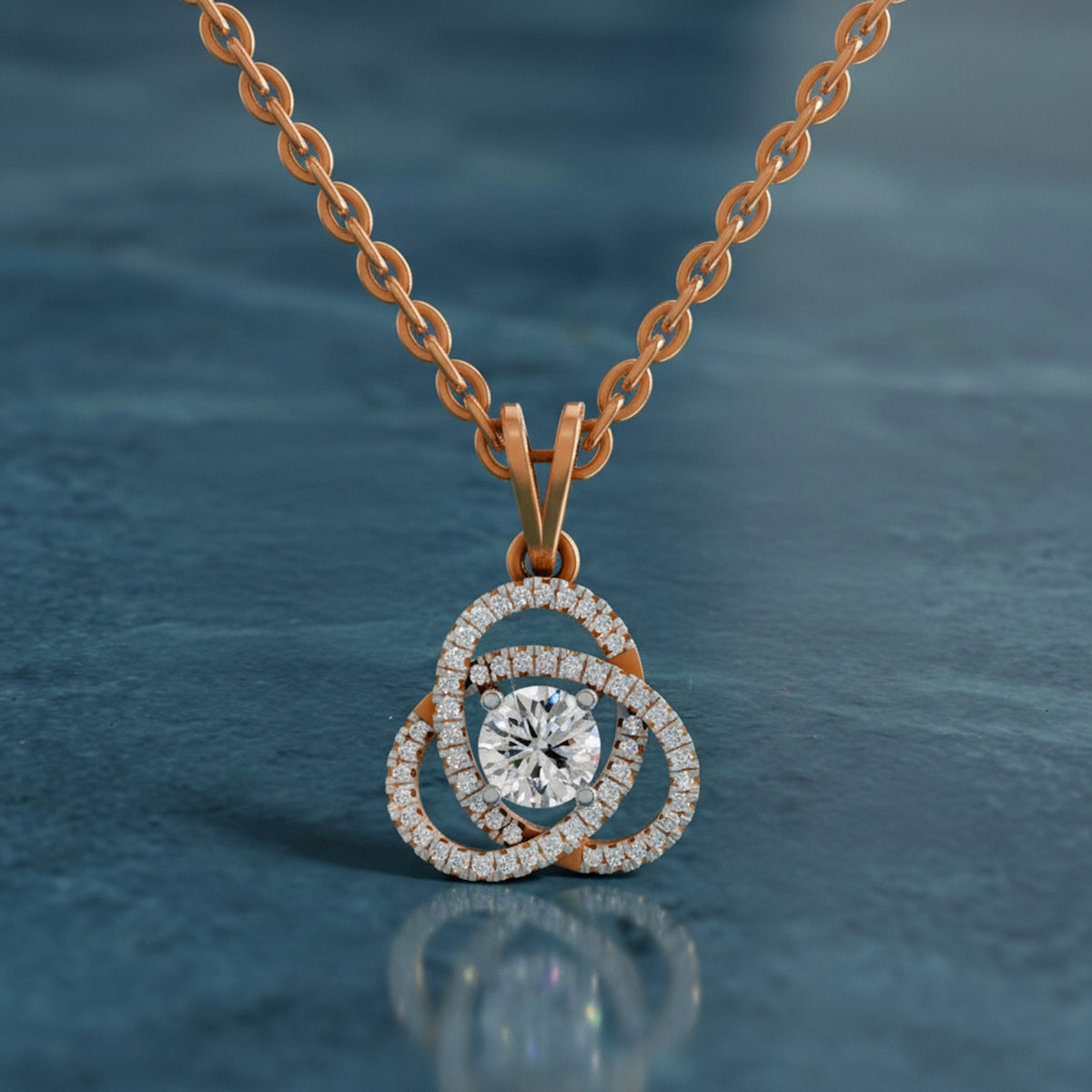 Rose gold necklace with a diamond pendant on a blue background