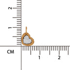 Heart-shaped pendant with glittery center on a ruler for scale