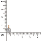 A small square pendant with a gold border and a pave-set white stone center, shown next to a centimeter ruler for scale on a white background.
