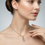 Woman wearing a silver necklace with a pendant on a neutral background