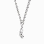A silver-toned necklace featuring a curb chain and a small wrap-style pendant with a row of clear gemstones, shown against a plain white background.
