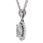 A silver-toned oval pendant necklace featuring a large clear center stone surrounded by a halo of smaller round stones, suspended from a matching chain on a plain white background.