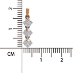 A close-up product photo of a small pendant with three clear round-cut stones in a rose-gold setting, shown next to a centimeter ruler for scale on a white background.