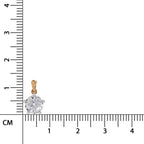 A small round-cut diamond pendant in a gold setting, positioned next to a black ruler with centimeter markings to show its size.