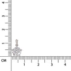 A silver pendant with a round clear gemstone in a prong setting, shown next to a centimeter ruler for scale on a white background.