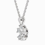 Lab grown diamond cluster pendant in BIS hallmarked white gold with round prong-set stones on a cable chain, side view