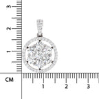 A round yellow gold pendant with a cluster of clear gemstones in the center and a halo of smaller stones around the edge, shown next to a centimeter ruler for scale on a white background.