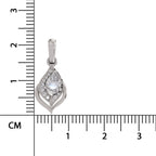 A silver teardrop-shaped pendant with a central clear gemstone surrounded by smaller stones, shown next to a centimeter ruler for scale on a white background.