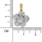A flower-shaped pendant with a yellow gold bail, featuring a central round clear stone surrounded by five petal clusters of small clear stones in silver-toned settings, shown next to a centimeter ruler for scale on a white background.