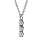A silver-toned necklace with a vertical pendant featuring three round clear gemstones in prong settings, suspended from a matching chain against a plain white background.