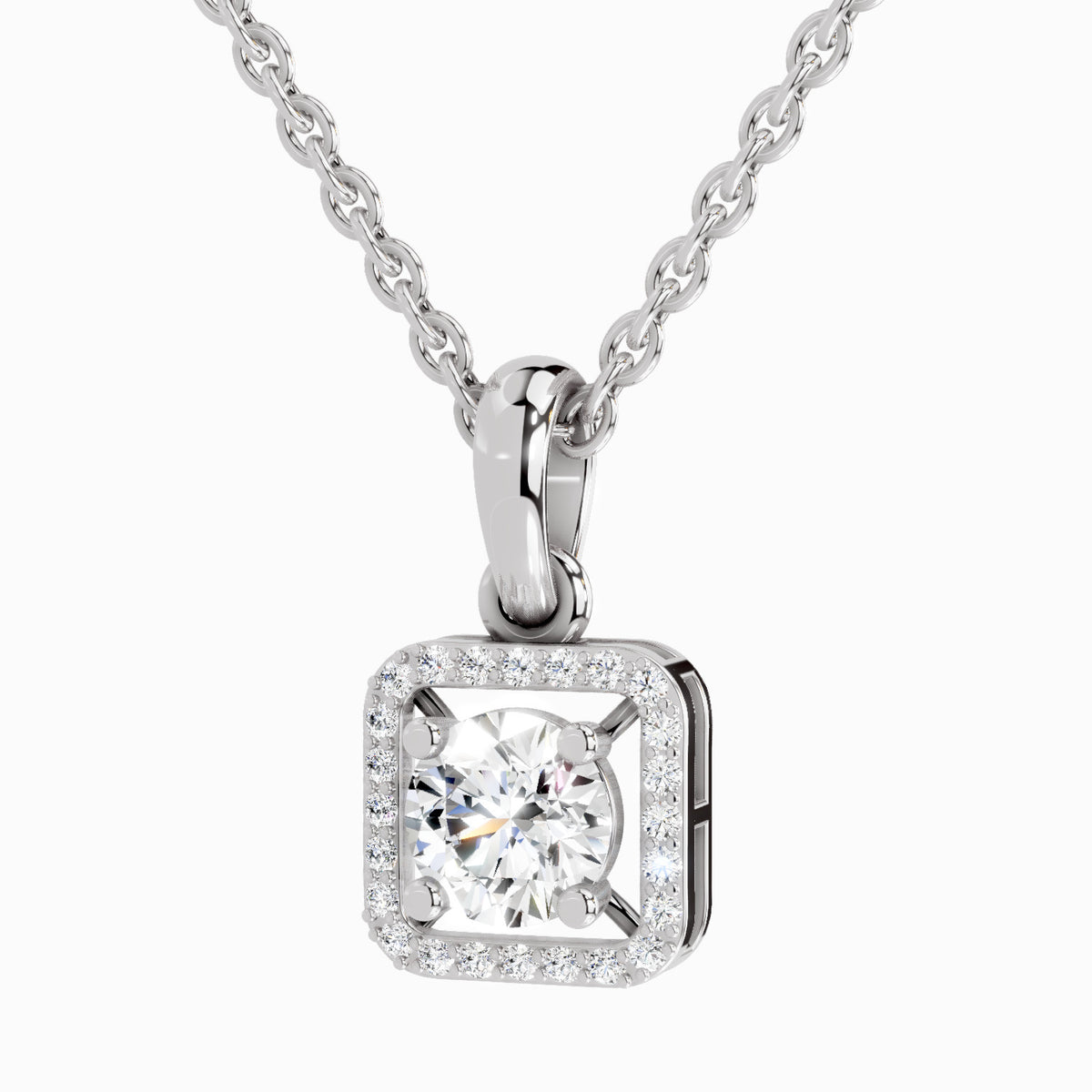 A silver square pendant necklace featuring a round-cut clear center stone surrounded by a halo of small clear stones, suspended from a silver chain on a light gray background.