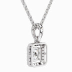 A silver-toned necklace with a geometric square pendant featuring a central clear gemstone, shown against a plain white background.