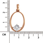 A rose gold oval pendant with a single round clear gemstone, shown next to a centimeter ruler for scale on a white background.