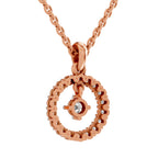 Rose gold necklace with a circular openwork pendant featuring a central bezel-set clear gemstone, shown on a white background.