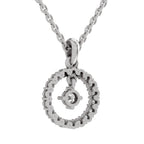 A silver necklace featuring a circular open pendant with a small anchor charm and a clear central gemstone, shown on a white background.