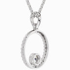 Silver circular pendant necklace on a white background