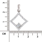 A silver diamond-shaped pendant with a central clear gemstone, shown next to a centimeter ruler for scale on a white background.