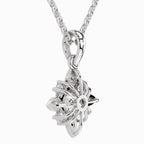 Silver necklace with a floral pendant on a white background