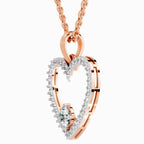 Rose gold heart-shaped necklace with diamonds on a white background