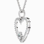 A silver-toned double-heart pendant necklace with a central clear gemstone, shown on a clean white background.