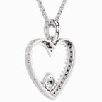 Silver heart-shaped pendant with a diamond on a white background