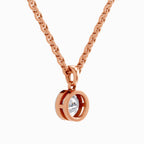 A rose gold chain necklace with a double-ring bezel pendant holding a clear round-cut gemstone, shown against a plain white background.