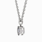 A silver-toned necklace with a curb chain and a double-ring bezel pendant holding a clear faceted gemstone, shown against a plain white background.
