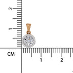 A round bezel-set pendant with a clear gemstone in a two-tone setting, shown next to a centimeter ruler for scale on a white background.