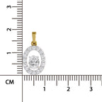 A yellow gold oval pendant with a halo of clear pavé stones and a central round-cut clear gemstone, shown next to a centimeter ruler for scale on a white background.