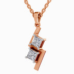 Elegant rose gold pendant necklace featuring two sparkling princess-cut diamonds in a modern geometric drop design, suspended from a delicate rose gold chain against a clean white background.